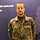 Ein Soldat steht vor einem blauen Hintergrund