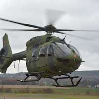 Ein Hubschrauber schwebt über dem Boden.