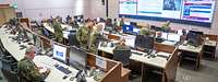 Several military personnel in an operations centre