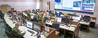 Several military personnel in an operations centre