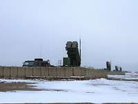 Vier militärische Raketenstartgeräte stehen in befestigten Stellungen mit je circa 100 Metern Entfernung zueinander.