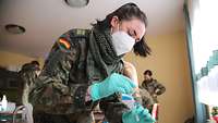 A female soldier performing a COVID-19 test