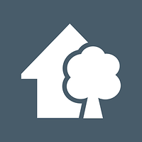 Ein grafisches Symbol eines Hauses mit Baum in Weiß auf grauem Hintergrund