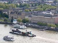 Equipment, Information Technology and In-Service Support A submarine is transported on a flat boat over a large river.