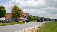 LKW-Kolonne erreicht ein Dorf