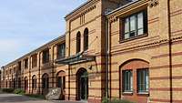 A two-storey building constructed with sand-coloured bricks