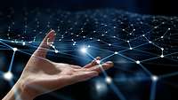 Eine Hand berührt ein virtuelles Netz