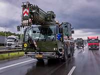 Ein Fahrzeugkran in voller Fahrt auf der Autobahn