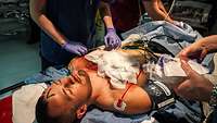 A patient lies on a treatment table with make-up injuries during the Role2Sea exercise