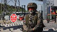 Two soldiers at a checkpoint at the entrance of a seaport