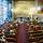 Ein Kirchsaal mit Menschen in den Bankreihen, ein Bischof spricht an einem Pult.