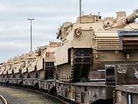  Several beige tanks in a row on a train