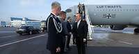  Minister Pistorius is greeted by the German military attaché in front of an air force aircraft.