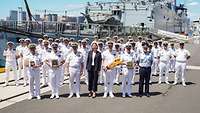  Arrival ceremony in the port of a host country. Uniformed marines in front of a warship.