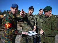  Soldiers in different uniforms are conferring on a railway track.