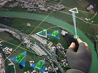  A digitized hand moves troops around a virtual sandbox.