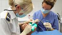 A dentist is treating a patient.