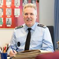  A man is sitting behind a desk
