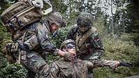 Soldiers treat a critical neck wound on a simulation mannequin CAESAR