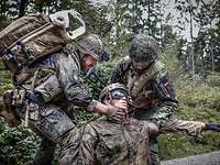 Soldiers treat a critical neck wound on a simulation mannequin CAESAR