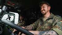 AT: Ein Soldat steht mit der Steuerkonsole vor einem abzuschleppenden Fahrzeug