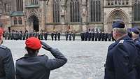 Soldatinnen und Soldaten stehen angetreten auf einem gepflasterten Platz
