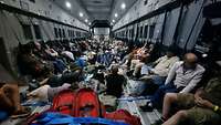 Civilians in a military aircraft during an evacuation operation