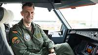 Ein Pilot sitzt im Cockpit eines Tankflugzeugs Airbus A330 MRTT und lächelt in die Kamera.