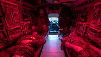 Blick ins Innere eines militärischen Fahrzeugs mit zwei liegenden Patienten auf jeweils einer Trage