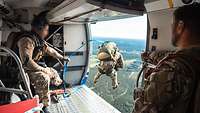 A soldier is jumping out of a helicopter