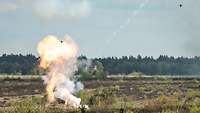Eine Drohne hat ihre Munition abgesetzt, Rauch steigt auf.