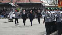 Several persons inspect a guard of honour