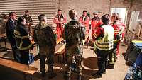 Soldiers, firefighters and medics in a joint briefing