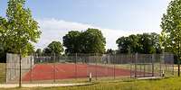 Umzäunte rote Tartanfläche mit Fußballtor und Basketballnetzen