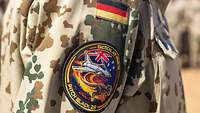 A uniform sleeve with the German flag and the patch for the Pitch Black 26 exercise.