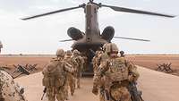 Mehrere Soldaten der Bundeswehr steigen in einen Hubschrauber
