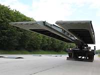 Armored bridgelaying vehicle with extended bridge